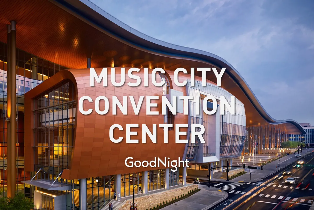 A striking architectural view of Music City Center, showcasing its modern facade, large glass windows, and curved roofline, set against a bustling backdrop ideal for conventions and professional gatherings.