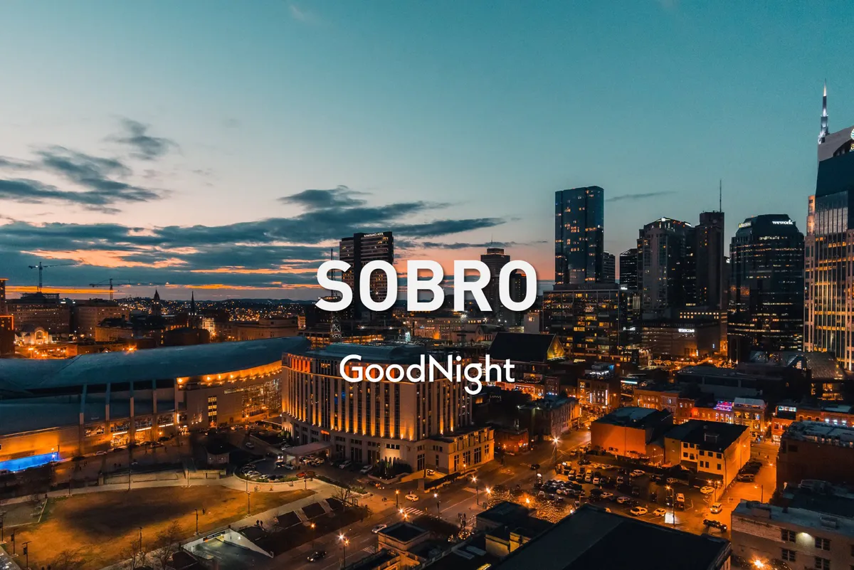 A panoramic view of the Nashville city skyline at sunset, with glowing streetlights and an inviting, lively city atmosphere. The image highlights the transition to nighttime activities and the city's vibrant after-dark persona.