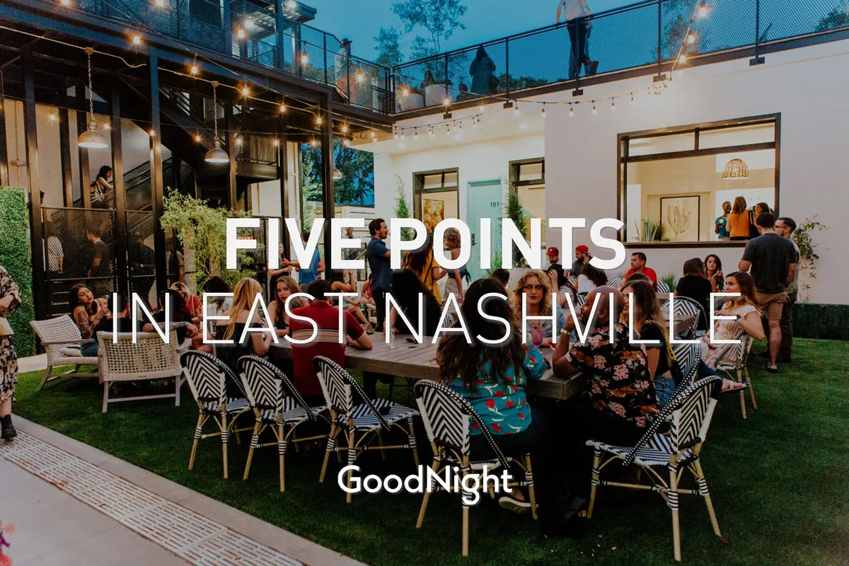 An exterior scene featuring an outdoor seating area adorned with string lights, where people are gathered and socializing. The festive mood and twinkling lights suggest a lively evening atmosphere ideal for intimate dinners and relaxed gatherings.