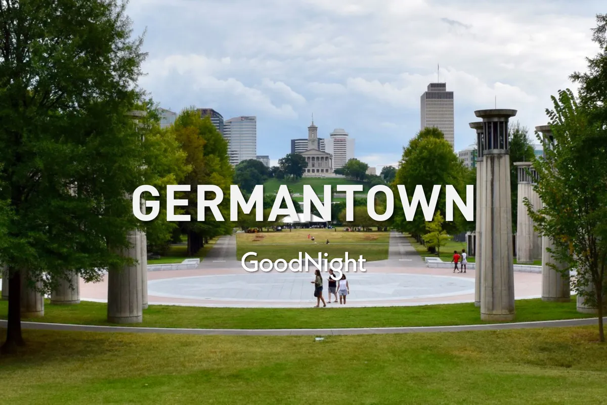 A serene exterior view of a sprawling green space with the city skyline in the background. Families and individuals enjoy evening strolls and social gatherings in an inviting urban park setting.
